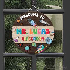 a welcome sign hanging from the side of a window