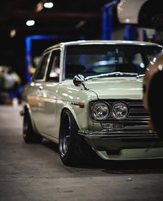 an old car is parked in a garage