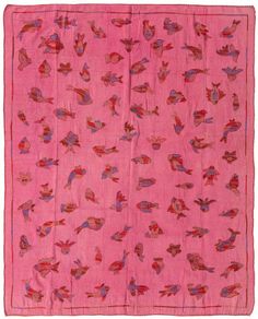 a pink rug with birds on it