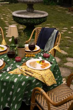 the table is set for two outside in the yard