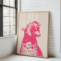 a pink and white poster with a cheetah on it in front of a window