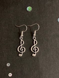 Pair of handmade silver treble clef earrings.  These earrings are made from silver colour treble clef charms and silver colour hook fastenings. The drop measures 4.5cm and they are 1cm wide. They are hand made by me. These earrings are a great gift, especially for someone who loves music. All purchases of jewellery or hair accessories come with a free lilac organza gift bag! I currently only post within the UK, Canada, USA and the European Union. Postage for additional items purchased in the sam Silver Nickel-free Music-themed Earrings, Music-themed Silver Earrings, Silver Music-themed Metal Jewelry, Music-themed Silver Metal Jewelry, Music Earrings, October Jewelry, Rabbit Earrings, Musical Gift, Original Necklace