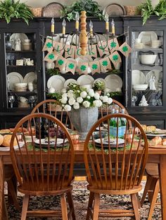 the dining room table is set for st patrick's day with green and white decorations