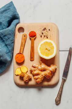 a cutting board topped with sliced up lemons and spices