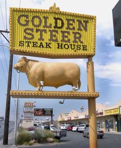 a yellow sign that says golden steer steak house