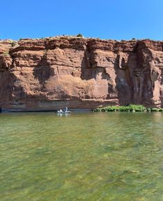 two people are kayaking in the clear water