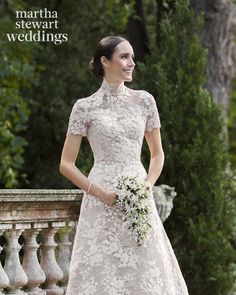 a woman in a wedding dress standing on a balcony