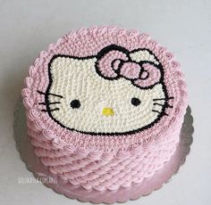 a hello kitty cake with pink frosting on top