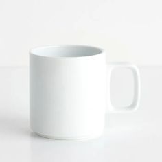 a white coffee mug sitting on top of a table