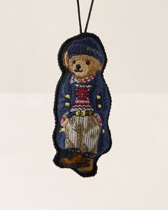 a teddy bear ornament hanging from a string