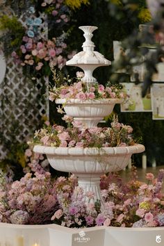 a large white fountain filled with lots of flowers