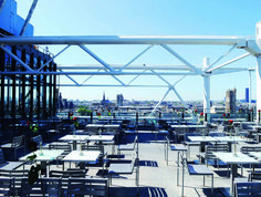 an outdoor dining area with tables and chairs