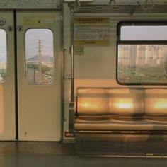 an empty subway car with its doors open and the sun shining through it's windows