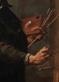 a man holding paintbrushes and an easel in his right hand