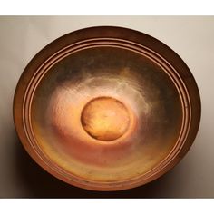 a large metal bowl sitting on top of a table