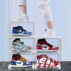 a person standing on top of a stack of shoes in different colors and sizes,