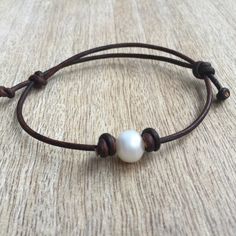 This lovely anklet is great for the beach. It was made using 100% dark brown leather cord. Designed for everyday wear. It is adjustable Note: Not Waterproof Please feel free to contact me if you have any questions This bracelet will be shipped by USPS First Class as soon as the payment is been received Check here for more anklets: https://www.etsy.com/shop/Fanfarria?section_id=17526074&ref=shopsection_leftnav_8 Check all Fanfarria's products: https://www.etsy.com/shop/fanfarria?section_id=16963242&ref=shopsection_leftnav_3 Want a custom order? Don't see your country listed for shipping? Have any questions? Send a convo or e-mail me Leather Anklets, Leather Cord Bracelets, Pearl Anklet, Pearl Leather, Couple Bracelets, Beaded Anklets, Anklet Bracelet, Cord Bracelets, Matching Bracelets