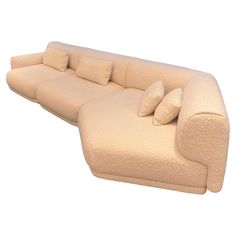 a beige couch with pillows on it