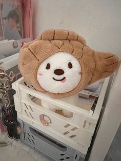 a stuffed animal that is sitting on top of a shelf next to scissors and other items