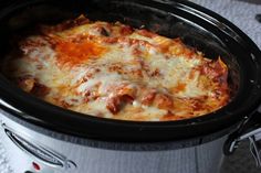 a crock pot filled with cheese and meat