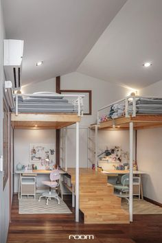 bunk beds in the middle of a room with wooden floors