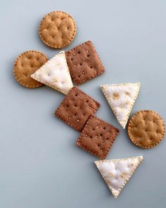 crackers and cheese are arranged in the shape of triangles on a blue surface