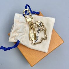 Add A Touch Of Luxury To Your Keys With This Louis Vuitton Keychain Micro Charm Lock And Key Gold Bag Charm Accessory. The Golden Metal Keychain Features The Iconic Lv Logo And Is Perfect For The Fashion-Conscious Woman Who Loves To Accessorize. The Keychain Is Durable And Strong, Ensuring That Your Keys Are Safely Kept. Things To Note: * No Tarnishing * Light Scratches * 100% Authentic * Box And Dust Bag Included Designer Gold Bag With Logo Charm, Designer Gold Bags With Logo Charm, Lv Keychain, Louis Vuitton Keychain, Lv Logo, Gold Bag, Louis Vuitton Accessories, Metal Keychain, Lock And Key