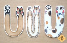 the letters u are made out of wood and have cats on them, including one cat