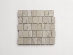 a white tile wall with squares on it