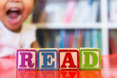 a child playing with blocks spelling the word read