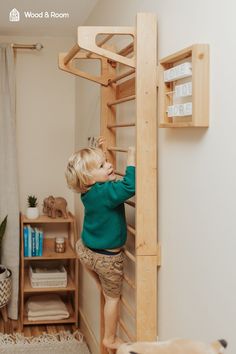 a young boy climbing up the side of a wooden bunk bed