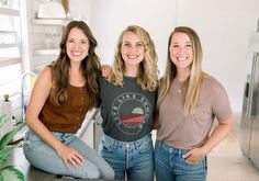 three women are posing for a photo in the kitchen