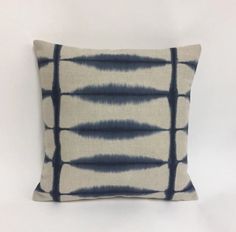 a blue and white pillow sitting on top of a table