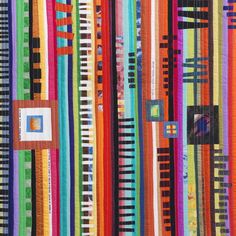 a multicolored striped quilt with squares and lines