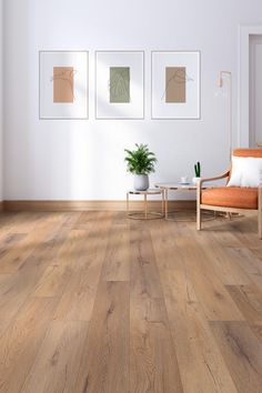 a living room with wood floors and pictures on the wall