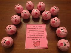 pink golf balls with pig faces on them and a poem written in front of them