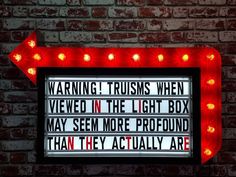 a neon sign that says warning trumps when viewed in the light box may seem more profound than they actually are