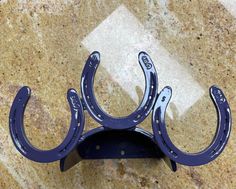 a pair of blue horseshoes sitting on top of a marble counter next to a tile floor