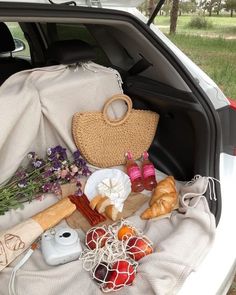 the trunk of a car filled with food and other things to eat in it's back