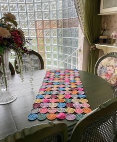 the table is covered with colorful crochet doily