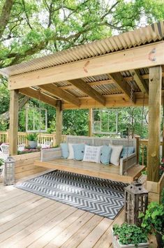 a wooden deck with a bench and potted plants