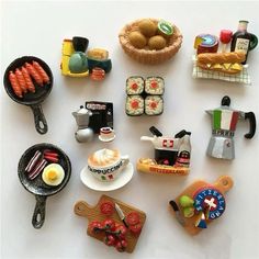 there are many small toy food items on the table together, including bread and eggs