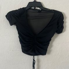 Condition: Never Worn 93% Nylon, 7% Spandex Cute Black Mesh Top Perfect For A Night Out Or A Concert Black Stretch V-neck Crop Top, Black Ruched Nylon Top, Fitted Ruched Elastane Crop Top, Fitted Ruched Tops In Polyamide, Fitted Ruched Polyamide Tops, Black V-neck Crop Top For Spring, Ruched Polyamide Tops, Black Stretch Polyamide Tops, Trendy Nylon Tops For Night Out