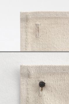 two pieces of cloth with buttons attached to the side of each piece, one in white and one in black