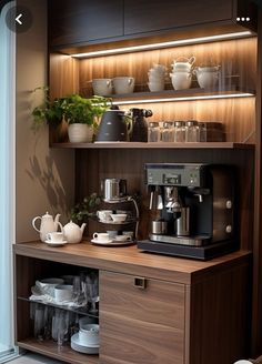 a coffee maker and some cups on a shelf