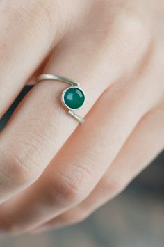 Sterling silver bypass green agate ring Are you looking for a delicate and simple jewelry for you or someone close to you? An everyday accessory in your favorite color or something little but precious that your friend can keep always with her? This green agate silver ring can be a great choice. The setting and the band are really subtle, but in the same time solid so it's not easy to damage it and you can wear this ring every day. The color of the gemstone is clear, deep and in a rather unique hue. The structure of the stone is regular, partly transparent so light penetrates it easily - because of it the stone changes it's color from deep green to a more delicate but still intense.  CHARACTERISTICS: * Material: sterling silver * Finish (you can see them on the last photo): rough/scratched Green Sterling Silver Minimalist Ring, Green Minimalist Sterling Silver Ring, Minimalist Green Jewelry With Simple Design, Minimalist Green Emerald Sterling Silver Ring, Minimalist Green Emerald Ring In Sterling Silver, Minimalist Green Agate Jewelry, Minimalist Sterling Silver Open Emerald Ring, Green Agate Ring, Green Stone Ring