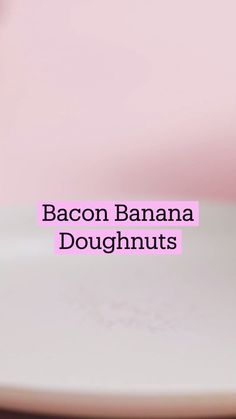 bacon banana doughnuts stacked on top of each other in front of a pink background