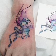 a person with a tattoo on their foot next to an image of a cartoon character