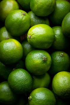 a pile of limes sitting on top of each other