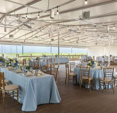 tables set up for an event with blue linens